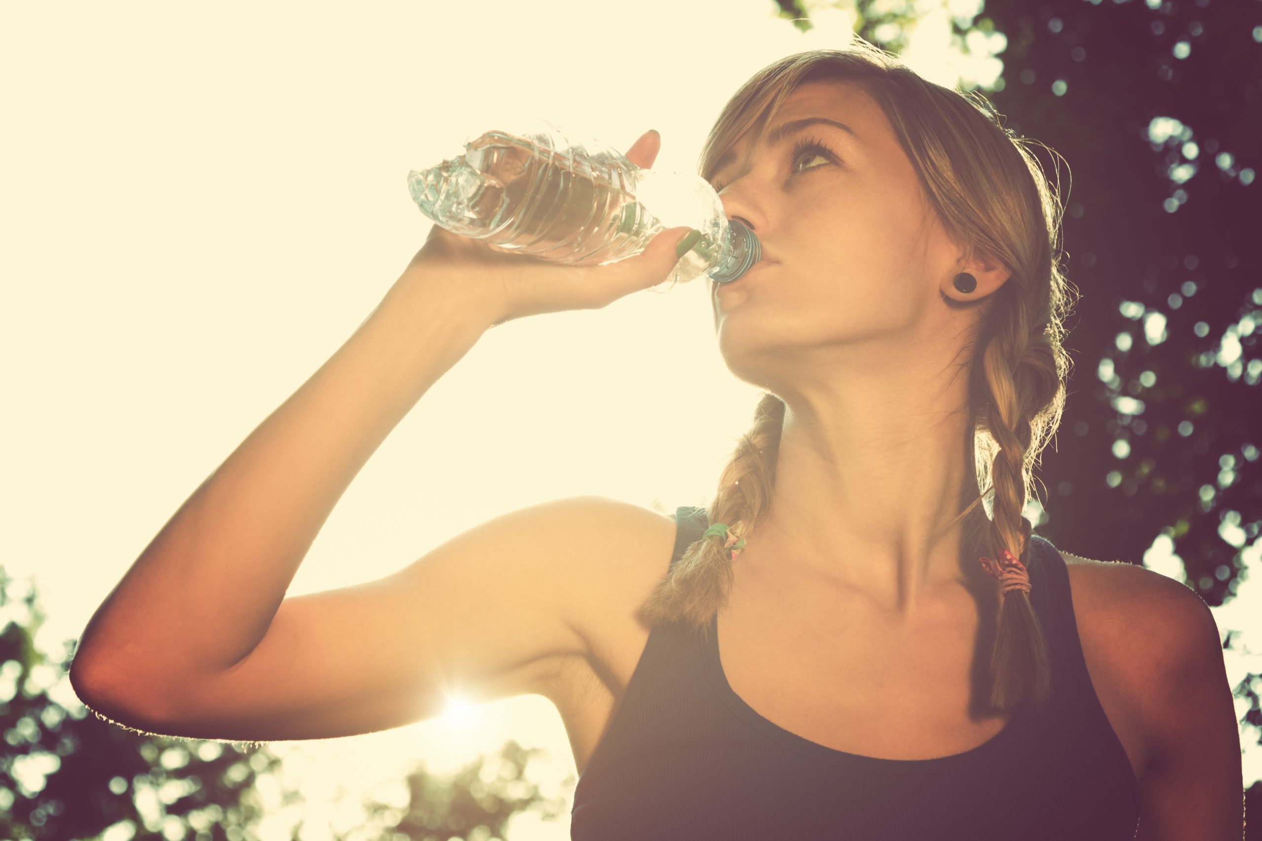 Woman drinking out of water bottle